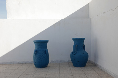 Jugs in front of a white wallの写真素材