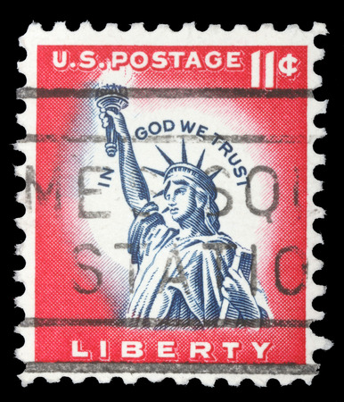 An 11 cents stamp printed in the United States features statue of liberty and inscription In god we trust, circa 1970のeditorial素材
