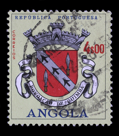 Stamp printed in the Angola shows Angolan Coat of Arms, Povoacao de Cuimba, circa 1963.のeditorial素材