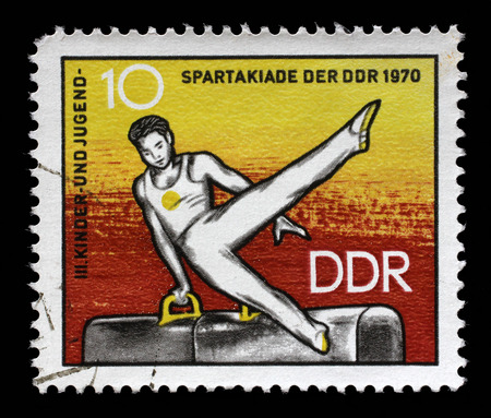 Stamp printed in GDR shows Athlete on Pommel Horse, 3rd Childrens' and Youths' Spartakiad, circa 1970のeditorial素材