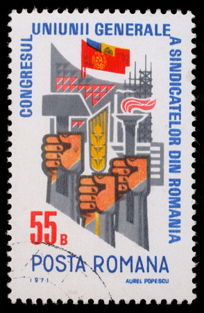 Stamp printed in Romania shows Trade Union Congress  Fists with hammer, ear and torch, circa 1971.のeditorial素材