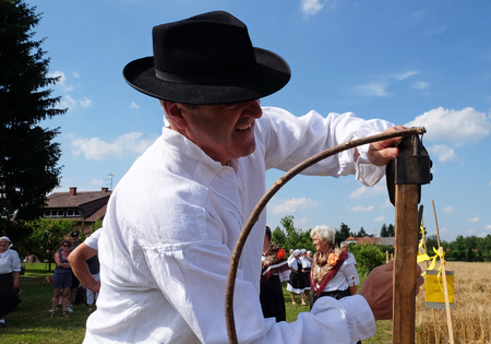 Farmer sharpening the scythe in the field in wheat fields in Nedelisce, Croatia on July 02, 2016のeditorial素材