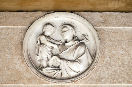 Saint Anthony of Padua bass relief in portico of church dei Santi XII Apostoli in Rome, Italyのeditorial素材