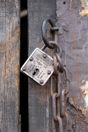 Ancient wooden door with iron lock and chain, Kolkata, Indiaのeditorial素材