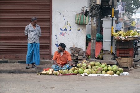 Unknown Indian sells coconuts on a city street in Kolkata on February 10, 2016.のeditorial素材