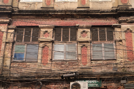 The chaos of cables and wires in Kolkata. Uncovered optical fiber technology open air outdoors in Asian cities, Kolkata, Indiaの写真素材