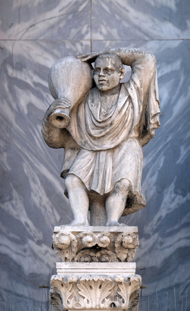 Sculpture of a man carrying a wine jug at St. Mark's Basilica, detail of the facade of the Saint Mark's Basilica, St. Mark's Square, Venice, Italy, UNESCO World Heritage Sitesのeditorial素材