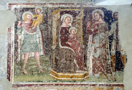 Enthroned Madonna and Child, Saints Christopher, Catherine, George and a worshipper Knight, fresco in the church of San Pietro Martire in Verona, Italyのeditorial素材