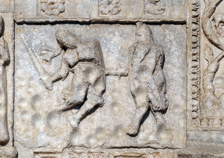 Bas-relief of Maestro Nicolo' (12th century), group to the right of the door of the Basilica of St Zenoの写真素材