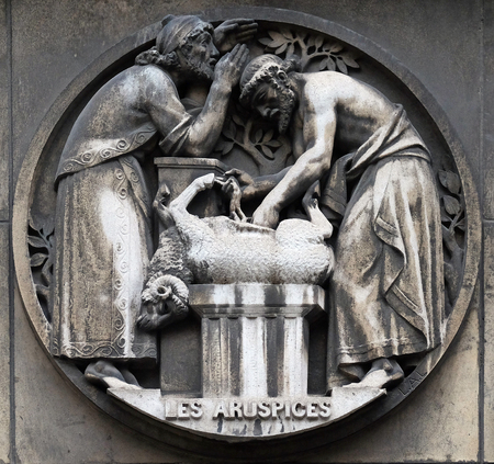 Aruspices, a priest in ancient Rome who practiced divination by the inspection of the entrails of animals. Stone relief at the building of the Faculte de Medicine Paris, Franceのeditorial素材