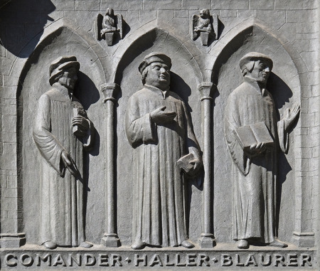 Fathers of the Reformed Churches of Switzerland: Comander, Haller, Blaurer, relief on the door of the Grossmunster church in Zurich, Switzerlandのeditorial素材