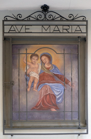 Virgin Mary with baby Jesus, house facade in Lugano, Switzerlandのeditorial素材