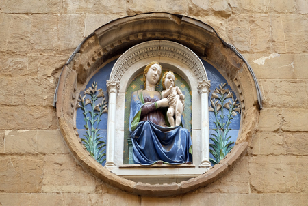 Medallion with the Virgin Mary and Child by Luca della Robbia on the facade of Orsanmichele Church in Florence, Tuscany, Italyのeditorial素材
