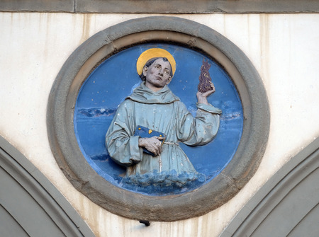St. Anthony of Padua, glazed terracotta tondo by Andrea della Robbia, located between two arches of the old Ospedale di San Paolo, in Florence, Italyのeditorial素材