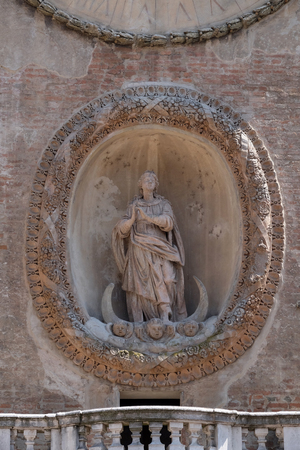 Virgin Mary statue on Clock tower of Palace of Reason (Palazzo della Ragione with the Torre dell'Orologio) in Mantua, Italyのeditorial素材