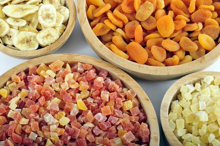 Dried and candied fruits in wooden bowlsの写真素材