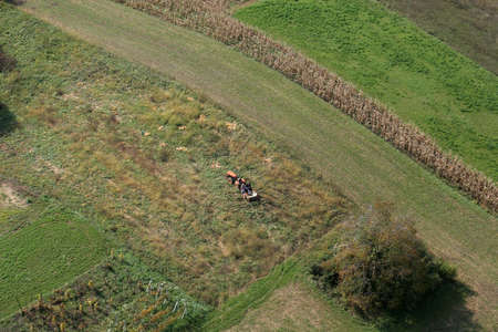 An aerial view of tractor working in a field in Sisljavic Croatia