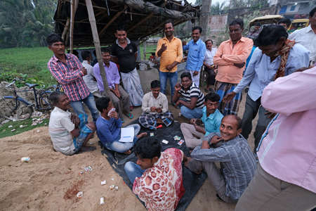 Men playing cards in a village  in Kumrokhali village, West Bengal, India