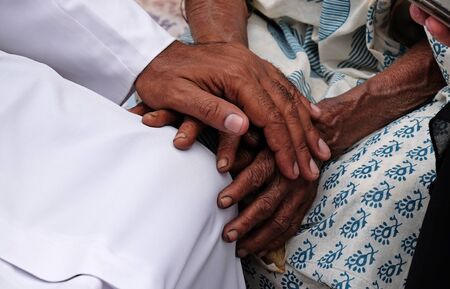 Hands, young and old, on top of each other, comforting each other, Kumrokhali, West Bengal, India