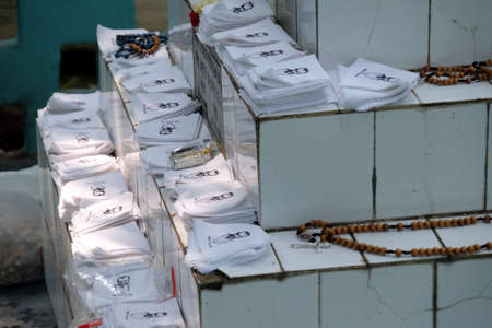 Religious objects are waiting for a blessing on the grave of Croatian missionaries, Jesuit father Ante Gabric in Kumrokhali, West Bengal, Indiaのeditorial素材
