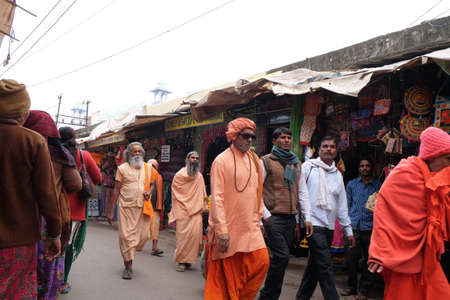 Indian sadhu holy man walking at the bazaar and collect alms in Pushkar, India