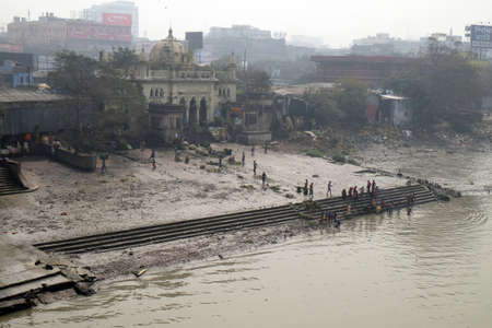 People bathing in river Hooghly under the busy Howrah bridge in Kolkata