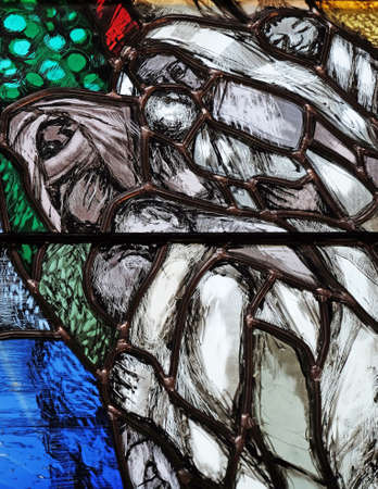 God bears the guilt of all mankind, takes hold of sinners and saves them from death, detail of stained glass window by Sieger Koder in St. John church in Piflas, Germanyのeditorial素材