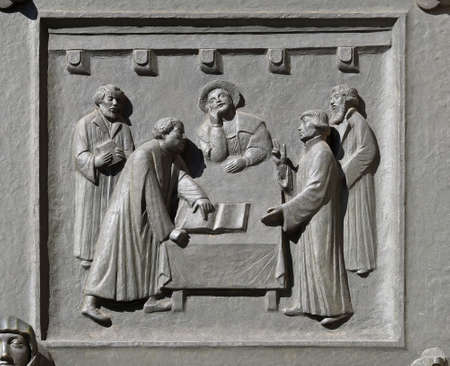 Luther and Zwingli dispute about the Lord's Supper at Marburg, relief on the door of the...