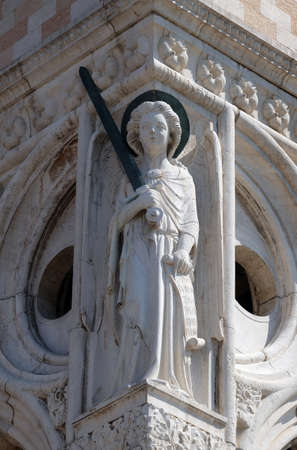 Sculpture of Archangel Michael with sword, detail of the Doge Palace, St. Mark Square, Venice, Italyのeditorial素材