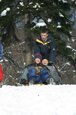 Landscape view of a snowy hill with families with children and people sledging and having fun in snow, Park Maksimir in Zagreb, Croatiaのeditorial素材