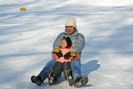 Landscape view of a snowy hill with families with children and people sledging and having fun in snow, Park Maksimir in Zagreb, Croatiaのeditorial素材