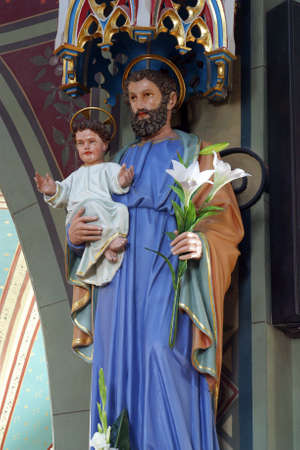 Saint Joseph holds the baby Jesus statue in the parish church of the Nativity of the Virgin Mary in Granesina, Croatiaのeditorial素材