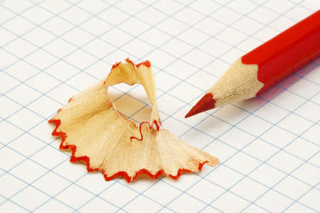 Red pencil shavings on a piece of paperの写真素材