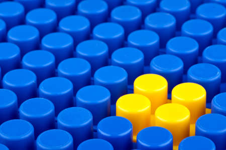 In the picture a bunch of blue plastic blocks and one yellow  They are not legos の写真素材