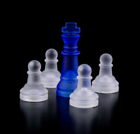 Blue captive king. Chess on a black background.の写真素材