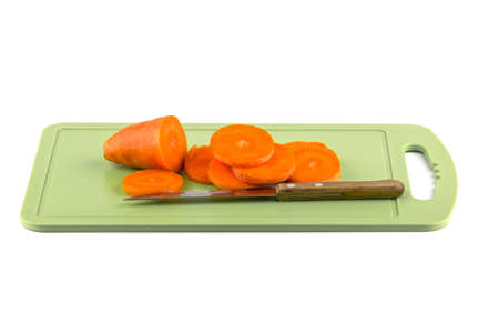 Sliced ââcarrots on a board with a knife.の写真素材
