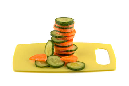Sliced ââcarrots and cucumber on the board.の写真素材