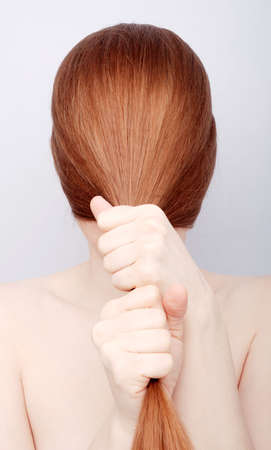 Portrait of the redhead young woman with long hairの写真素材