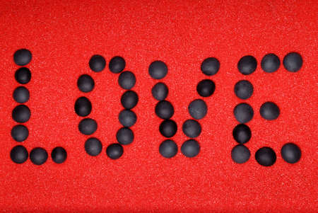 Word love from stones on red sandの写真素材
