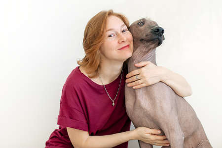 A woman hugging with a Mexican Hairless Dogの写真素材