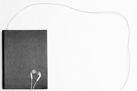 Headphones and books on table. Concept of audiobook.の写真素材