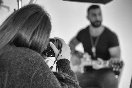 Photographing in the studio, a photographer and a model enjoy filming.の写真素材