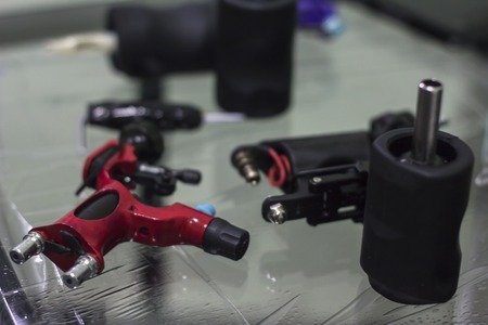 tattoo machine is on the table in a tattoo studio closeup.の写真素材