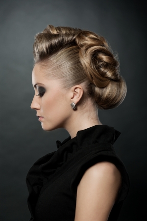 Blond woman with fashion hairstyle, eyes down の写真素材