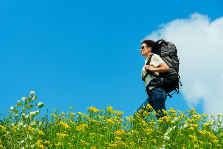 Hiking in the grass, sky backgroundの写真素材