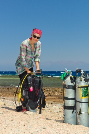 Woman diver prepares for diveの写真素材