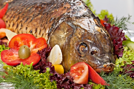  	Baked fish decorated with vegetables and prepared for the Banquetの写真素材