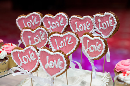 Cookies in the shape of a heart with the inscription "love".の写真素材
