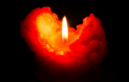 One candle flame at night closeupの写真素材