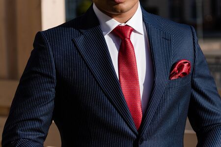 Man in suit buttoning his jacketの写真素材